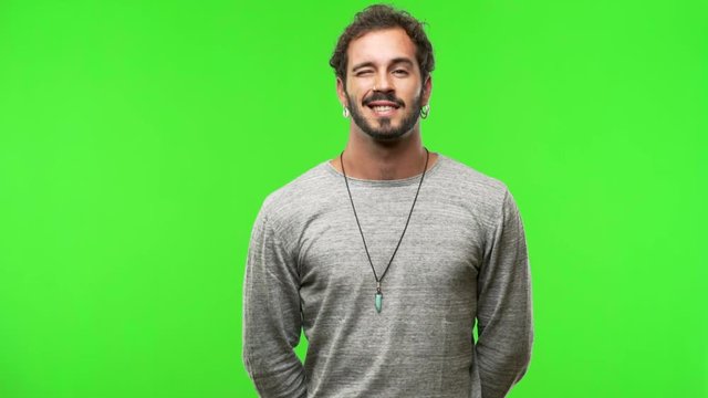 young man on chroma green screen winking