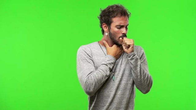 young man on chroma green screen coughing