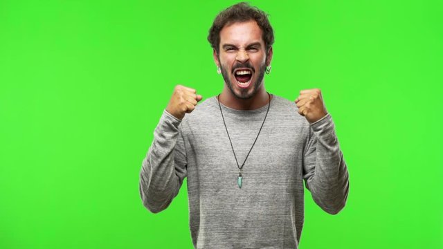 young man on chroma green screen screaming angry