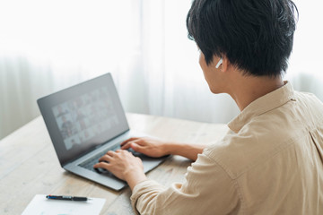 One man working remotely and a cat.