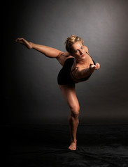 Ballerina dance in studio, black background