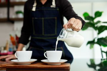 coffee maker pours milk mixed with hot coffee