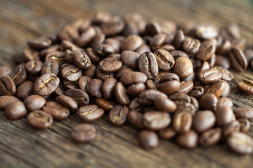 Close-up of coffee beans on a wooden table, macro shot