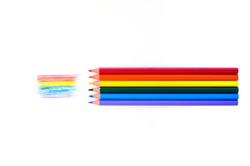 Lgbt rainbow flag on white background and colored pencils of all colors of the rainbow adjoining their color. View from above