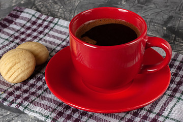 A cup of black aromatic freshly brewed coffee with homemade cookies