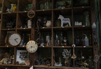 Bangkok, Thailand - Jun 26, 2020 : Wall clocks and Collectibles on handmade wooden rustic wall shelf in Living room Vintage style. No focus, specifically.
