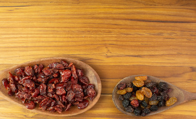 two spoons full of  craberries and raisin