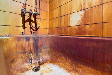 Rust stains in bathtub on wall and bath. High level Iron dissolved in a water. Ferrous Iron