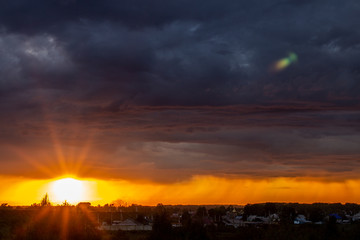 Very beautiful sunset in the city or village. Pink-orange sky with clouds.