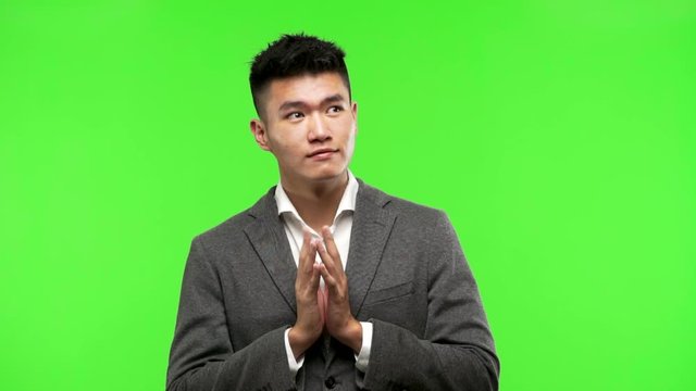Young chinese business man devising a plan