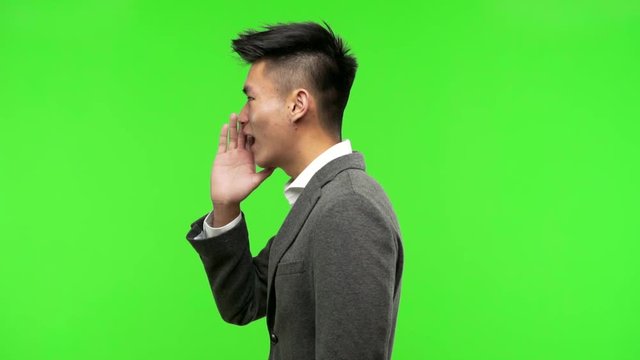 Young chinese business man whispering gossip undertone