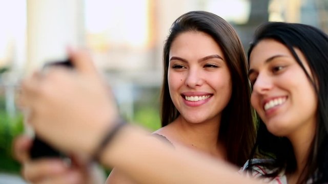 Millennial girls taking a selfie photo with smartphone