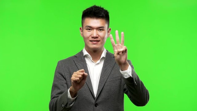 Young chinese business man showing number six
