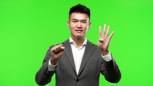 Young chinese business man showing number ten