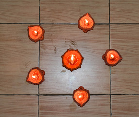  oil lamp or Diwali Diya also known as diva made of clay glowing decoration in diwali festival in front of flat. Diwali is biggest festival of India. Diwali is festival of lights and happiness.
