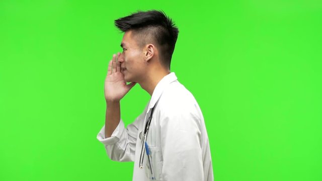 Young chinese doctor man whispering gossip undertone