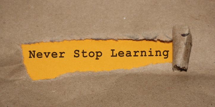 Brown torn Paper and yellow background with never stop learning written
