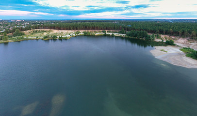 Lake near the forest and the city in the background