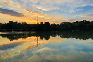 Colorful scenery with a lake reflection of an evening sky