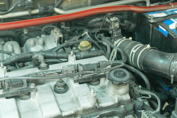 Old ignition coil on my car engine, Car maintenance service.