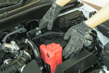 Car maintenance service, Auto mechanic Checking car battery.