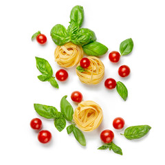 Cherry tomatoes, pasta and basil leaves on a white isolated background. Flat lay, copy space. Gamedients for dinner.