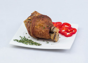 Fried pork knuckle with red bell pepper on white background