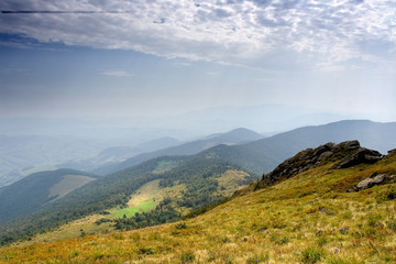 Summer day in the mountains under a bottomless sky with clouds