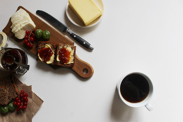 homebaked bread. toast with butter and jam. on a wooden background. homemade breakfast.