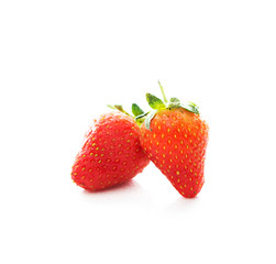 Two red fresh strawberries on a white background, close-up