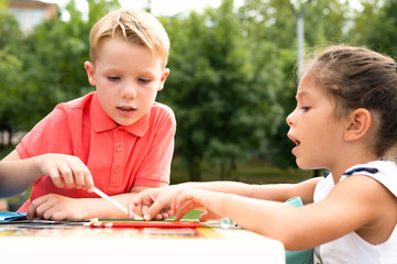 Children draw pictures with colored pencils when they leave school after the Coronavirus confinement