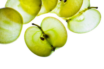 Slices of apple at the backlight isolated on a white background, macro photo