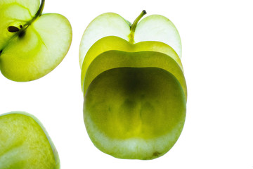 Slices of apple at the backlight isolated on a white background, macro photo