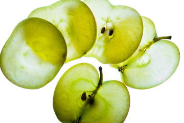 Slices of apple at the backlight isolated on a white background, macro photo