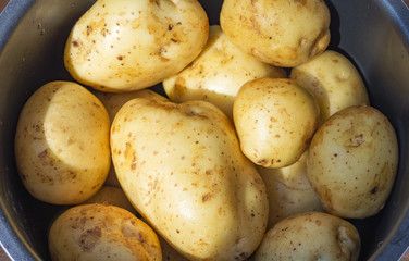 Raw uncooked new potatoes at home.