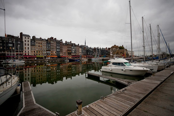 Yachts in the black port in Normandy before the rain