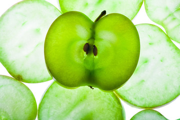 Slices of apple at the backlight isolated on a white background, macro photo