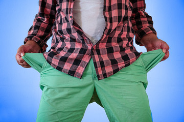 A man in trousers with empty pockets turned out. On a blue and white background.