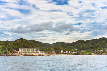 Naklejka premium Coast of the Kanaya Marina along the Uraga Channel with the loop ramp of the Futtsu Kanaya Interchange in front of the Mount Nokogiri in the Bōsō Peninsula.