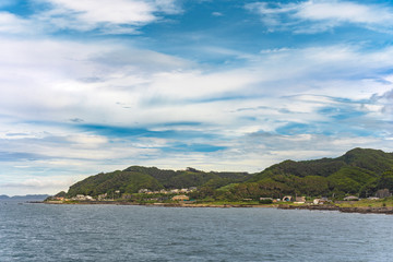 Coast of the Bōsō Peninsula from the ferry sailing on the Uraga Channel with the Kanaya town at the foot of the Mount Nokogiri.