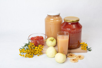 Apple jam and juice, fresh and dried apples, flowers, still life, homemade concept, natural food.