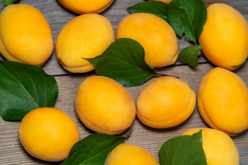 apricots and leaves on a wooden table