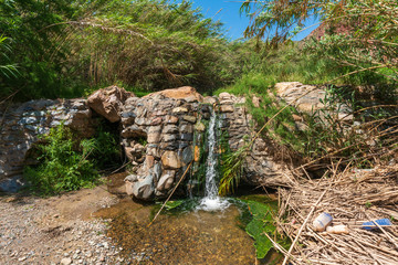 Fototapeta na wymiar Water flowing down a waterfall in a river