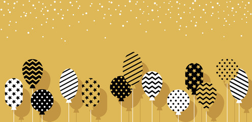 Balloons in black, white, golden colors.