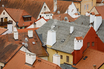 An autumn view of old/antique rooftops captured from Zamecky Park in Cesky Krumlov, Czechia