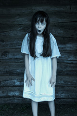 Scary ghost girl openes mouth isolated on dark background