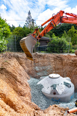 construction site with cistern made of cement filled by a crane
