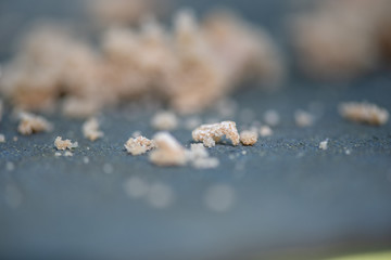 Bread crumbs in a bird feeder with a close-up photographed with a shallow depth of field.
