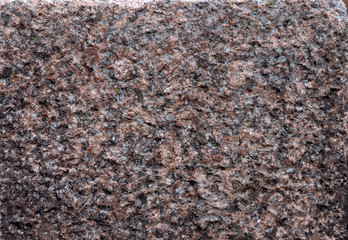 Texture of pink Baltic granite with quartz and mica feldspar granules