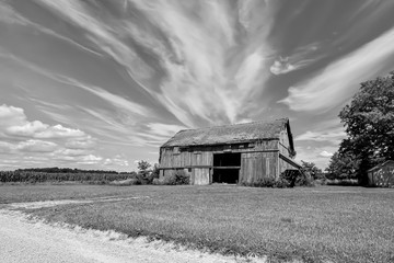 Fantastic old barn with a cloudy sky in black and white.